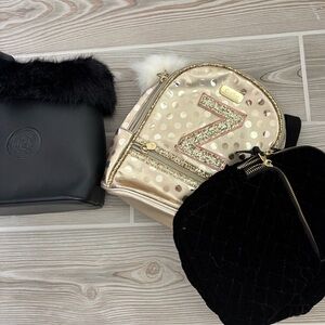 2 small backpacks and a purse